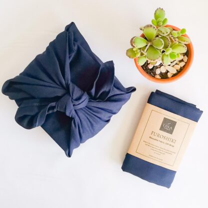 Furoshiki fabric gift wrap replaces single-use paper.